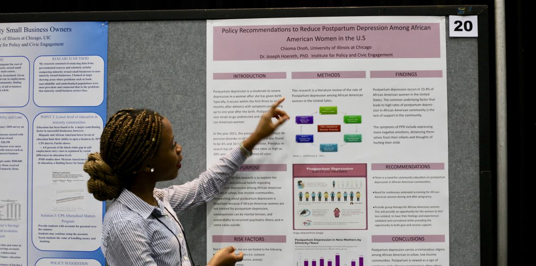 student presents research poster